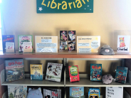 Children's book display with poster and artwork/pictures