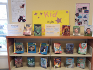 A children's book display with lots of posters on a sunny day