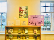 A children's book display with posters and adventure books
