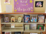 A children's book display with lots of artwork scattered throughout the books.