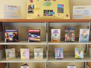 A children's book display with a gold poster